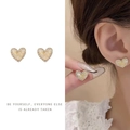 Macro detail of a heart-shaped pearl earring with rhinestone borders and gold trim - Heart Rhinestone Marble Clip-on