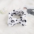 Plush black and white cow print headband with a soft bow for face washing and makeup - White Leopard