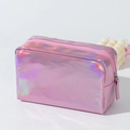 Macro view showing the metallic laser holographic PU surface and zipper of the pink makeup bag - Pink