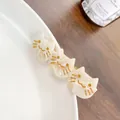 Chic acetate cat-themed hair clip featuring three beige kitten heads with gold accents - 6.5cm / Off-white