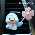 Close-up of cute blue penguin car air vent clip with pink bow and clover ornament - Blue Penguin