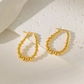 Macro shot of gold-plated teardrop hoop earrings crafted with polished metal beads - Beaded Water Drop Hoop