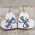 Detail of heart-shaped faux leather hockey earrings with blue patterns on stone - Hockey