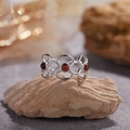 Detail of silver S925 ring with amber garnets on natural rock in soft lighting - Natural Garnet Flower Goddess Ring LR390