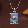 Detail of silver tarot pendant with blue enamel sun design and Roman numeral XIX - Silver (X6041SY)