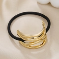 Macro shot of gold layered metal hair cuff with high-elastic black rubber band - Gold Hollow Double Layer