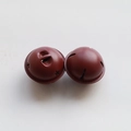Macro view of two 4cm red metal star-cutout bells for DIY Christmas decor - Wine Red