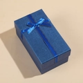 Detail of blue rectangular gift box with textured finish and elegant ribbon bow - 14x8x6cm / Blue