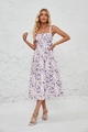 Detail view of floral print sleeveless dress featuring a side slit and elegant patterns - White With Blue Floral