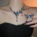 Close-up of luxury gold flower jewelry set with blue and clear zircon on a female model - 18# Blue Flower (2-Piece Set)