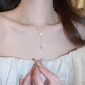 Detail of double-layer gold necklace with white camellia pendant and pearls on a model - 30# Necklace-Gold Pearl Camellia Double Layer (Waterdrop)