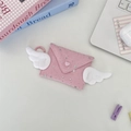 Close-up of pink envelope coin purse with white plush wings and silver star details - Bright Star Light Pink