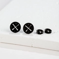Detail of matte black stainless steel compass stud earrings with laser-cut cross arrows - 443 Black (Compass)