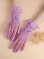 Detail of purple lace mesh bridal gloves with bow tie and pearl accents - Light Purple