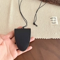 Detail shot of a black leather key holder necklace pendant with a hanging strap - Black Glasses Clip