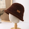 Detailed view of plush dark brown bucket hat with decorative leather patch on side - Coffee