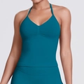 Detail view of peacock blue halter sports bra with gathered center and elastic knit fabric - Malachite green