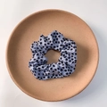 Floral print hair scrunchie in light blue fabric with black floral patterns and elastic folds - Black Dotted Floral