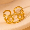 Detailed view of golden interlocking geometric oval chain ring on a textured surface - Gold 143
