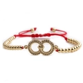 Pulsera tejida roja ajustable con dije de infinito dorado y micro-pavé de circonitas - Doble Anillo Dorado + Cuentas Doradas + Cuerda Trenzada Roja