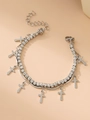 Macro view of silver layered chain bracelet featuring rhinestone star and cross charms - Cross / Silver