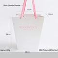 White trapezoid gift bag with pink handles and blooming print for flower packaging - Double-sided Embossed Trapezoidal Pearl Pink