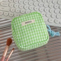 Detail of green gingham storage pouch with blue rope zipper pull and logo patch - Green Check