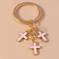 Golden keychain with three pink enamel cross pendants on a round metal ring - Pink
