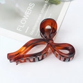 Large dark brown resin hair claw clip with a bow design and polished tortoiseshell finish - Red Leopard