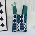 Knitted tote bag with emerald and navy geometric patterns and checkerboard design - Green Background With Blue Dots