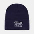 Detail of navy blue beanie featuring white I AM ENOUGH embroidery and knit texture - Navy Blue
