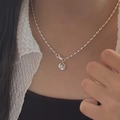Silver beaded necklace with a round star engraved pendant worn by a model - Silver Star Beaded Necklace (XL1553)