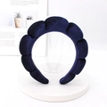 Close-up of deep blue velvet sponge headband with wavy cloud design on a display stand - Navy Blue