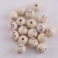 Flat lay of 20mm natural wood beads with cute animal face patterns and center holes - Cat