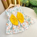 Detailed close-up of a floral pet dress with a large yellow bow on a wooden hanger - Yellow Floral