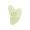Close-up of a light green heart-shaped resin gua sha tool with reflective white background - Jade / Emerald Green
