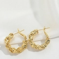 Detailed macro view of the twisted texture and golden finish on these hoop earrings - Spiral Style