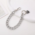 Detailed view of silver rhinestone chain with black heart bow pendant on white base - K1975 Rhinestone Chain