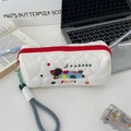 Close-up detail of quilted white pencil case with cute dog embroidery and red zipper - White (Colorful Dog Style)