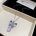 Detail of silver butterfly pendant with pink teardrop crystal on black velvet display - Purple Necklace