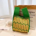 Chic green and yellow striped knit tote bag with geometric arrows for daily style - Green