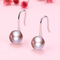 Elegant lavender pearl earrings with silver drop hooks on soft pink floral background - White Gold / 5mm Purple Natural Pearl Earrings