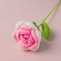 Handmade crochet rose with pink and white petals on a soft pink background - Gradient Bright Pink Rose