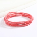 Close-up of pink handmade glass seed bead multi-layer body chain with elastic texture - Hot Pink