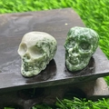 2.8cm natural crystal skull figurines in green and white jade on a wooden base - Green Spot Jasper