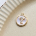 Macro detail of a gold letter T pendant with shimmering shell and zircon inlay - T Round