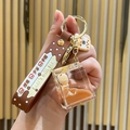 Brown bubble tea keychain with floating bear doll inside a liquid glitter square bottle - Milk Carton Bear