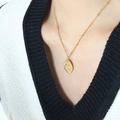 Retro gold-plated titanium necklace with female portrait pendant on a model's neck - 40+5cm / Gold Necklace
