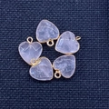 Five heart-shaped pink quartz stone pendants with gold plating on a blue fabric background - 15x18mm / Rose Quartz
