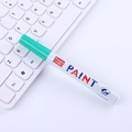 Green oil paint marker with 2.8mm tip on white keyboard background for art and diy - Green